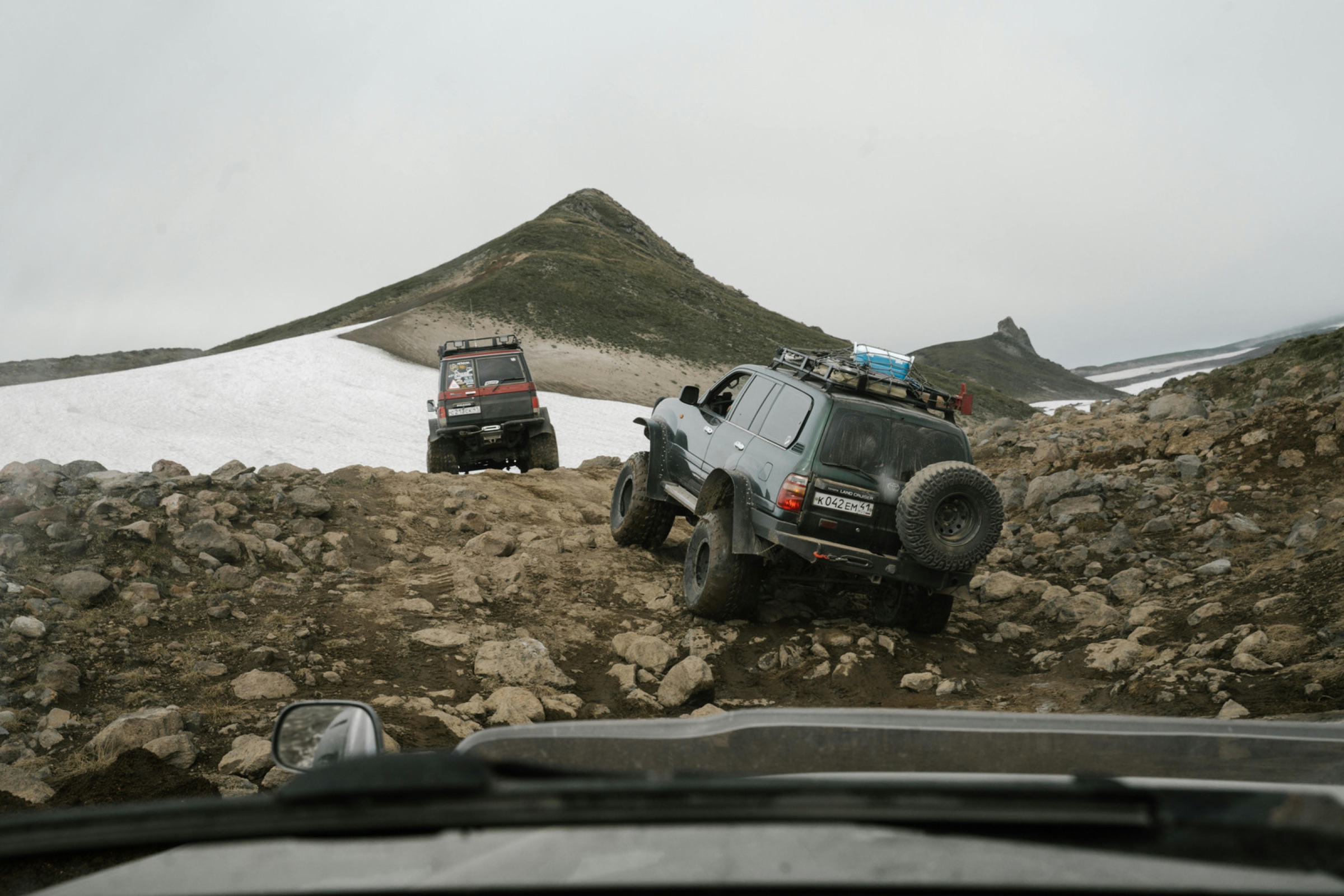 Overland rig crossing a high mountain pass